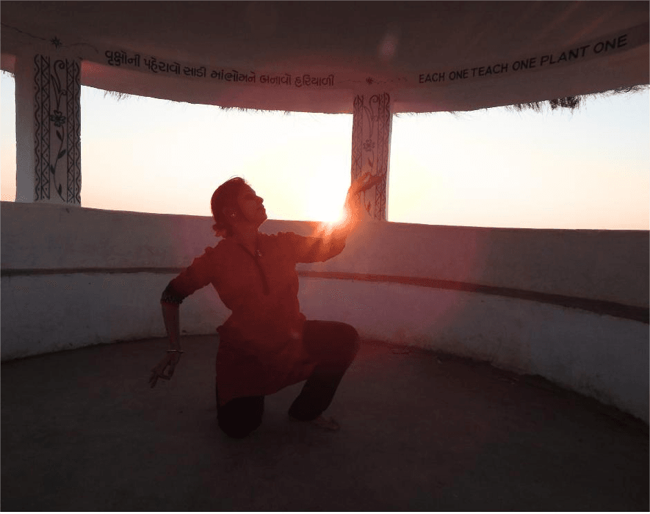 Leesa Mohanty in dance pose silhouetted against sunset